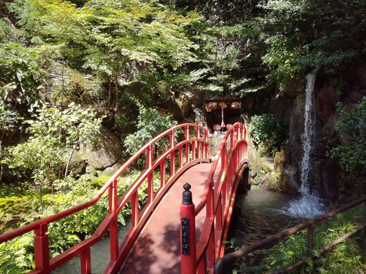 Red bridge with waterfall
